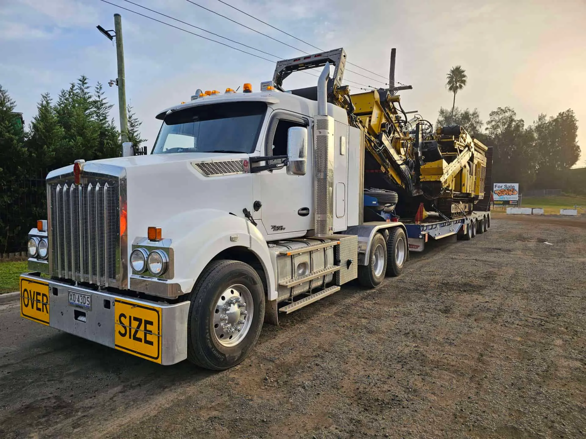 Truck floating a crusher out to a job site