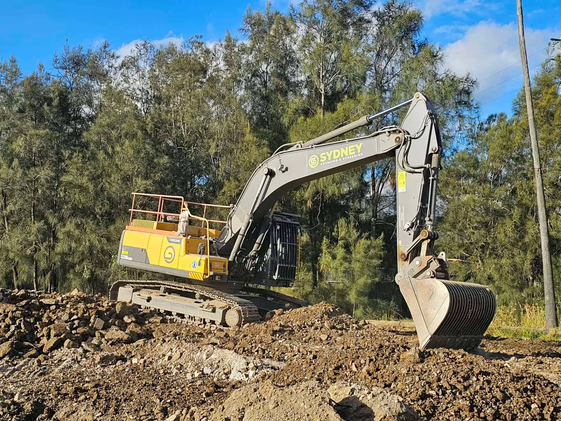 Excavator parked beside a stockpile on a Sydney work site