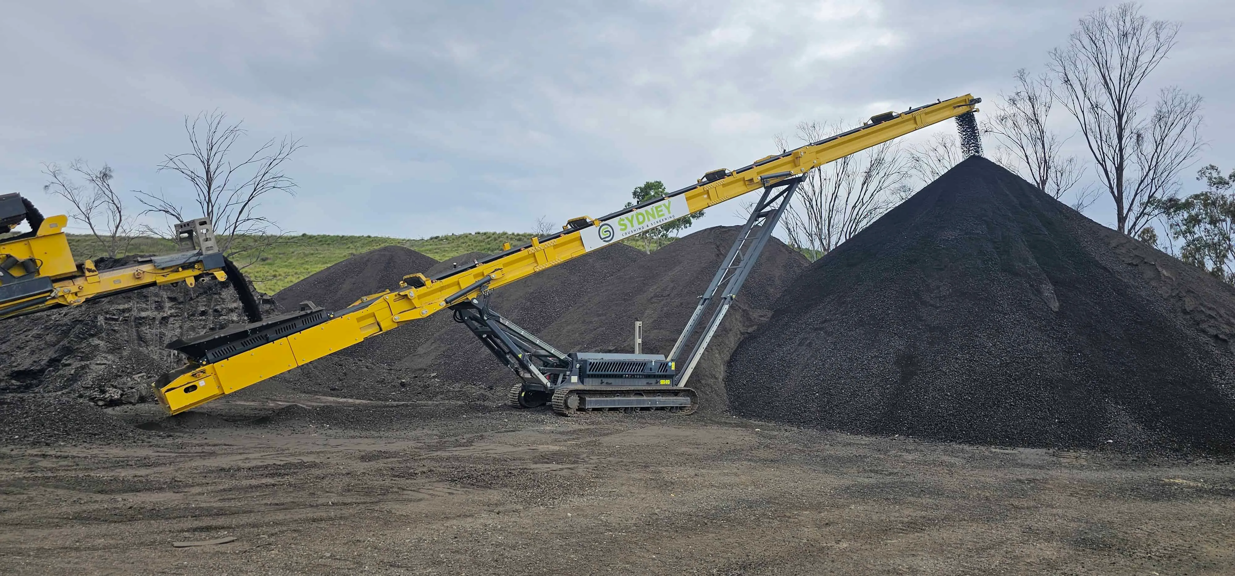 Aerial view of a conveyor stacking crushed asphalt