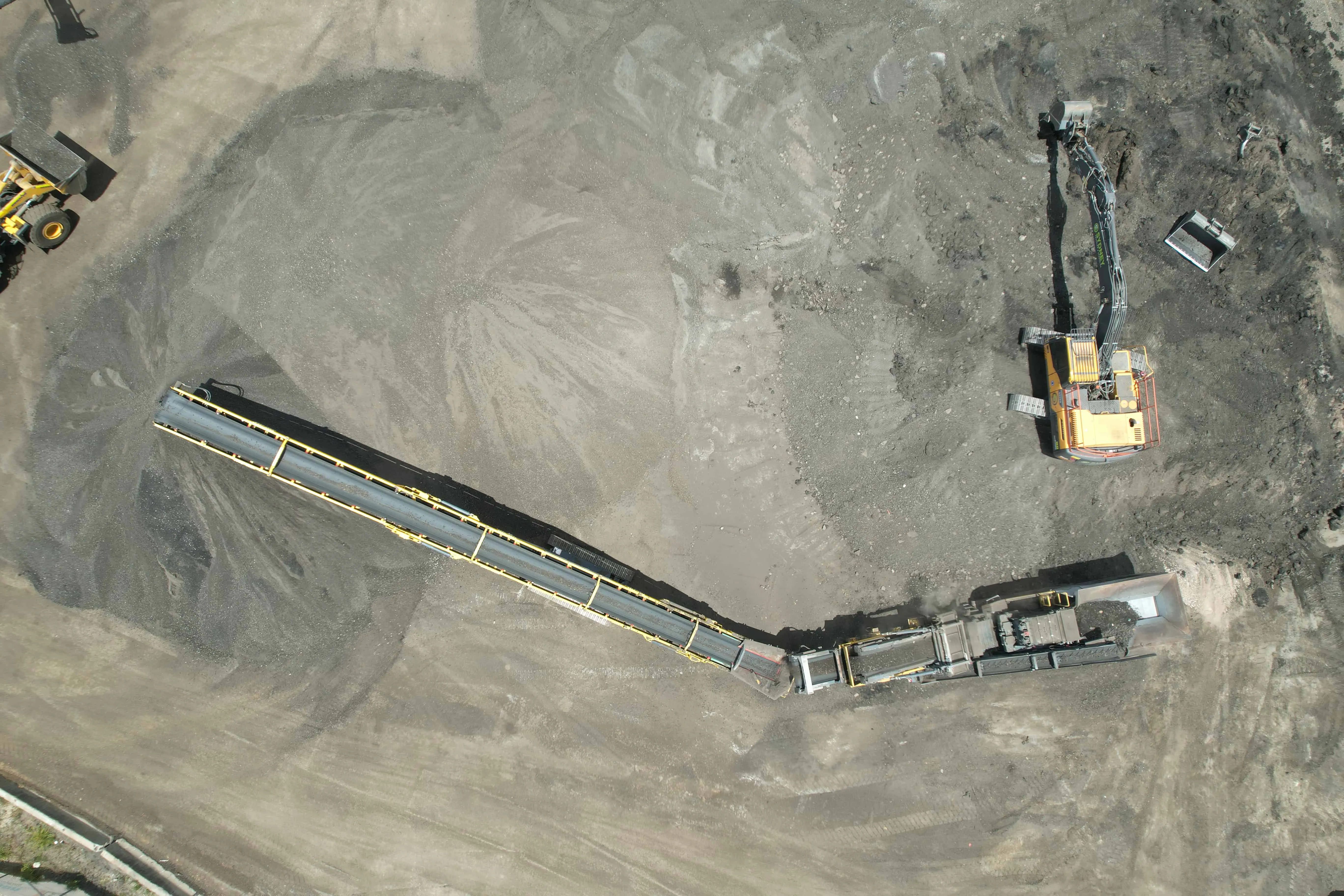 Aerial view of the crusher and conveyor processing asphalt