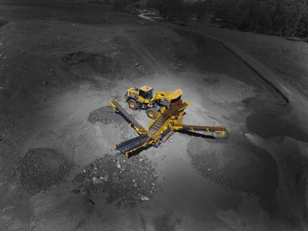 Screening plant separating soil into graded stockpiles
